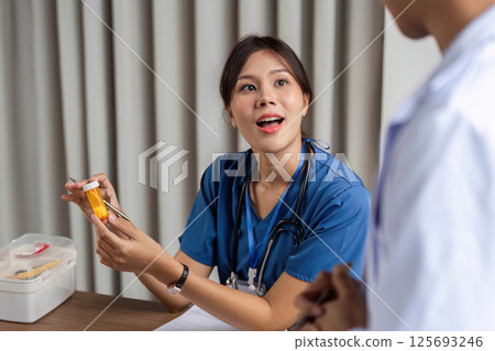 Doctor presenting medication information joyfully to a patient 125693246