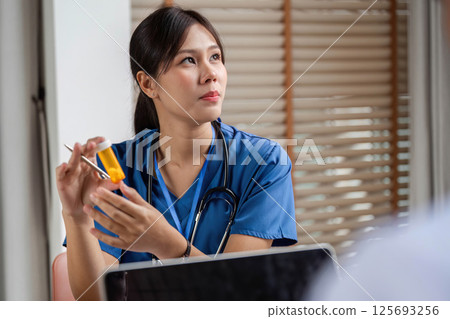Doctor sharing important medication details in a detailed consultation Doctor sharing important medication details in a detailed consultation 125693256