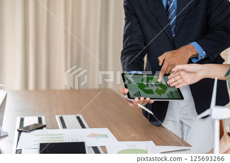 ESG data presentation with professionals analyzing digital trends ESG data presentation with professionals analyzing digital trends 125693266