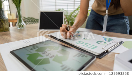 ESG sustainability planning with tablet and documents ESG sustainability planning with tablet and documents 125693268