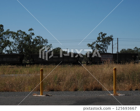 Freight train on the North Coast Line, Boyne Island, QLD, Australia Freight train on the North Coast Line, Boyne Island, QLD, Australia 125693667