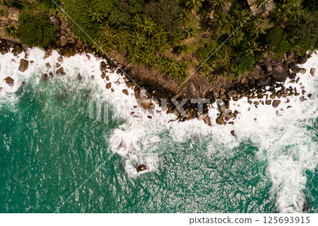Top view waves crashing on rocks seascape background,Wide angle sea nature background Top view waves crashing on rocks seascape background,Wide angle sea nature background 125693915