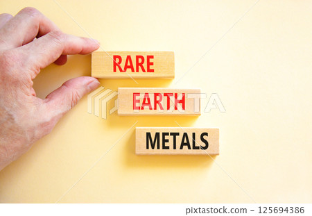 Rare earth metals symbol. Concept words Rare earth metals on beautiful wooden block. Businessman's hand. Beautiful white background. Business and rare earth metals concept. Copy space. Rare earth metals symbol. Concept words Rare earth metals on beautiful wooden block. Businessman's hand. Beautiful white background. Business and rare earth metals concept. Copy space. 125694386
