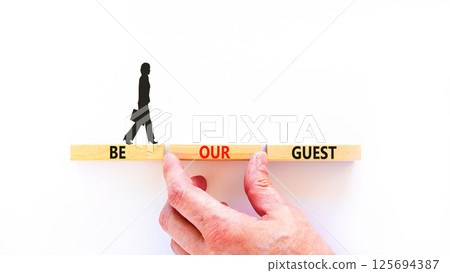 Be our guest symbol. Concept words Be our guest on beautiful wooden block. Businesswoman's icon. Beautiful white background. Business and be our guest concept. Copy space. Be our guest symbol. Concept words Be our guest on beautiful wooden block. Businesswoman's icon. Beautiful white background. Business and be our guest concept. Copy space. 125694387