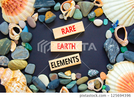 Rare earth elements symbol. Concept words Rare earth elements on beautiful wooden block. Sea stones and shells. Beautiful black background. Business and rare earth elements concept. Copy space. 125694396