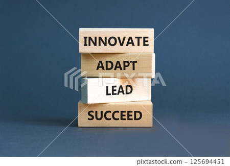 Innovate adapt lead succeed symbol. Concept words Innovate Adapt Lead Succeed on beautiful wooden blocks. Beautiful grey background. Business innovate adapt lead succeed concept. Copy space. Innovate adapt lead succeed symbol. Concept words Innovate Adapt Lead Succeed on beautiful wooden blocks. Beautiful grey background. Business innovate adapt lead succeed concept. Copy space. 125694451