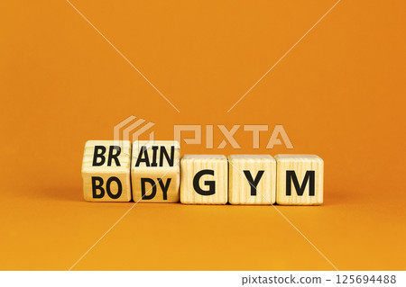 Body vs brain gym symbol. Turned wooden cubes and changed words Body gym to Brain gym. Beautiful orange table orange background, copy space. Business and body vs brain gym concept. Body vs brain gym symbol. Turned wooden cubes and changed words Body gym to Brain gym. Beautiful orange table orange background, copy space. Business and body vs brain gym concept. 125694488