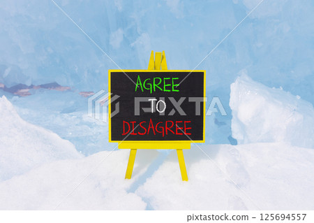 Agree to disagree symbol. Concept words Agree to disagree on beautiful blackboard. Beautiful blue ice and snow background. Business and agree to disagree concept. Copy space. 125694557