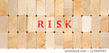 Risk symbol. Concept word Risk on beautiful wooden blocks. Beautiful wooden blocks background. Business, lifestyle, support and risk concept. Copy space. Risk symbol. Concept word Risk on beautiful wooden blocks. Beautiful wooden blocks background. Business, lifestyle, support and risk concept. Copy space. 125694565
