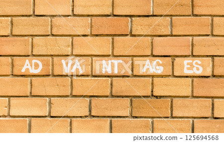 Advantages symbol. Concept word Advantages on beautiful brown bricks. Beautiful brown brick wall background. Business advantages concept. Copy space. 125694568