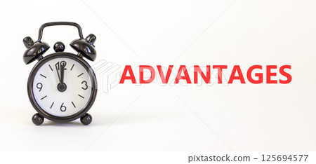 Advantages symbol. Concept word Advantages on beautiful white paper. Beautiful white paper background. Black alarm clock. Business advantages concept. Copy space. Advantages symbol. Concept word Advantages on beautiful white paper. Beautiful white paper background. Black alarm clock. Business advantages concept. Copy space. 125694577