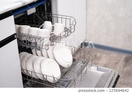 Built-in dishwasher door open. Kitchen with built-in appliances 125694642