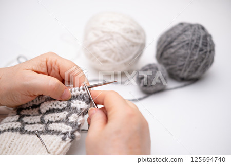female hands knitting close up female hands knitting close up 125694740