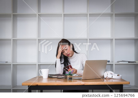 Stressful asian businesswoman with huge amount of credit card debt. Stressful asian businesswoman with huge amount of credit card debt. 125694766