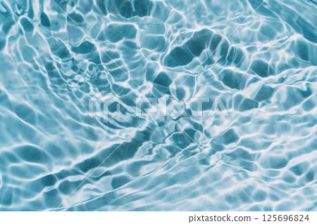 Blue water background with waves and glare Blue water background with waves and glare 125696824