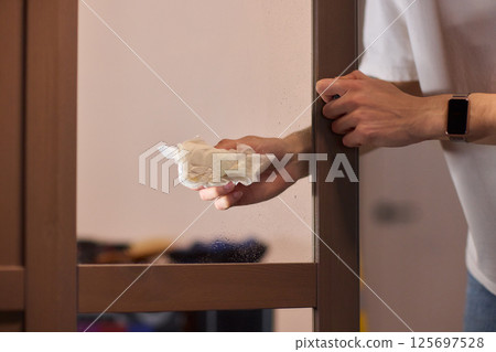 Meticulously Cleaning the Glass Surface with Care and Attention to Detail and Efficiency 125697528