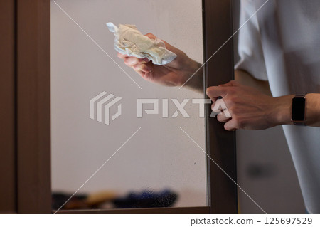 Meticulously Cleaning the Glass Surface with Care and Attention to Detail and Efficiency 125697529