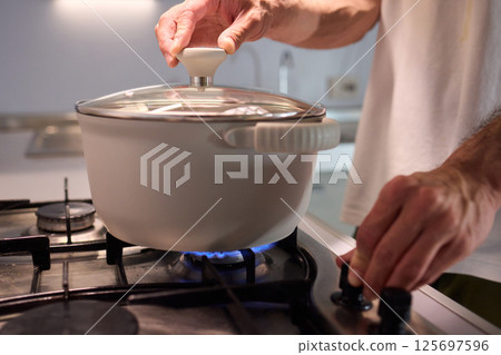 Preparing meals on the stove using a pot can be a delightful culinary experience 125697596