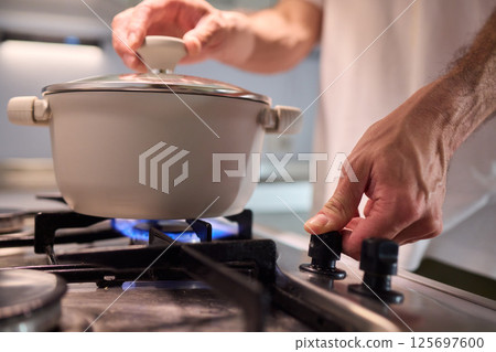 Preparing meals on the stove using a pot can be a delightful culinary experience 125697600