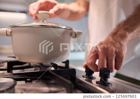 Preparing meals on the stove using a pot can be a delightful culinary experience 125697601
