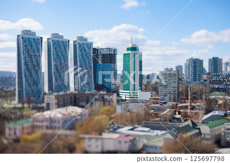 Striking tilt-shift cityscape featuring a mix of modern and older architecture 125697798