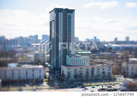 Striking tilt-shift cityscape featuring a mix of modern and older architecture 125697799