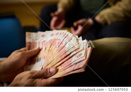 A Cash Transaction That Carries Unsettling and Uneasy Undertones of Tension and Anxiety A Cash Transaction That Carries Unsettling and Uneasy Undertones of Tension and Anxiety 125697950
