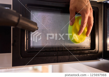 Learn to sanitize a sponge in the microwave for optimal kitchen cleanliness and hygiene Learn to sanitize a sponge in the microwave for optimal kitchen cleanliness and hygiene 125697988