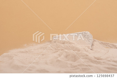 beach sand with copy space and grey concrete stone platform podium for cosmetics or products. on beige background. 125698437