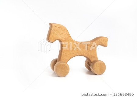 Toy - handmade wooden horse on wheels isolated on white background 125698490