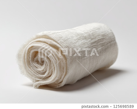 Sterile rolled gauze bandage resting on white background 125698589