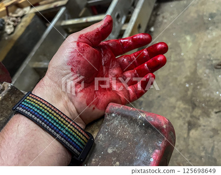 Crime scene with human hand in blood on the floor 125698649