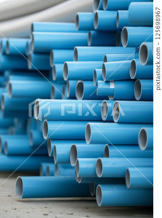 Pvc pipes stacked at construction site material storage area 125698967
