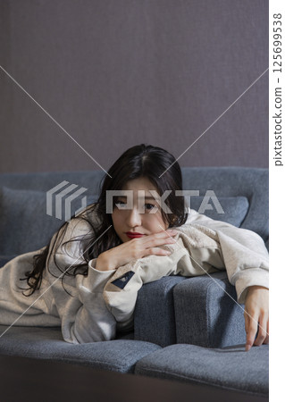 Woman relaxing on sofa 125699538