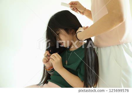 East Asian Girl with Mom 125699576