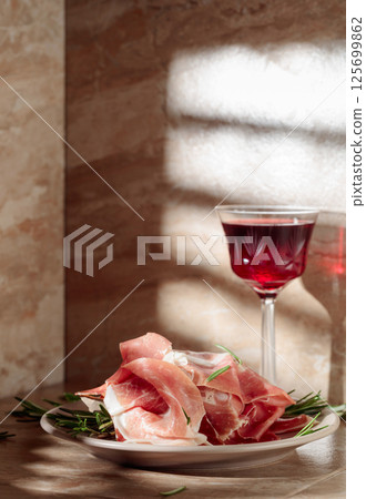 Prosciutto or Spanish jamon with rosemary and red wine. 125699862