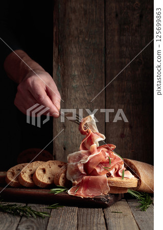 The hand of a prosciutto thief. 125699863