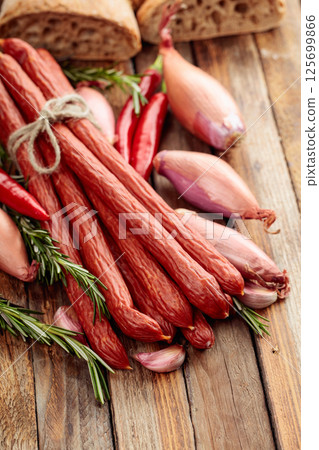 Smocked sausages with onion, garlic, pepper, and rosemary. Smocked sausages with onion, garlic, pepper, and rosemary. 125699866