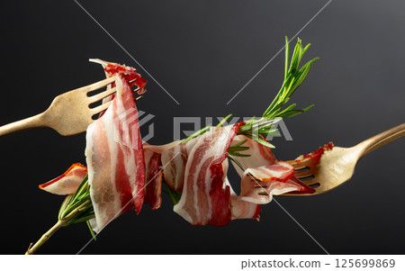 Dry-cured pork belly bacon with rosemary. Dry-cured pork belly bacon with rosemary. 125699869