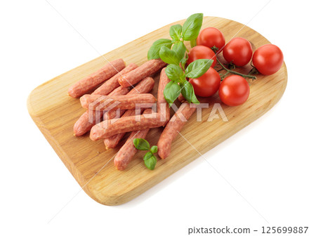 Sausages with basil and tomatoes isolated on a white background. 125699887