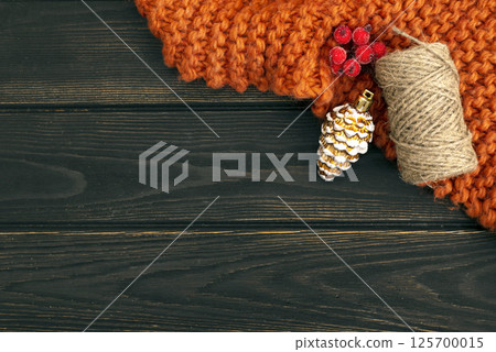 Christmas dark wood background with decorations: plaid, cone, berry and twine thread with copy space. Greeting card Christmas dark wood background with decorations: plaid, cone, berry and twine thread with copy space. Greeting card 125700015
