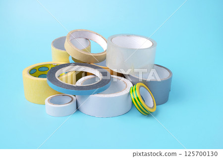 many different kind of scotch tapes on a blue background 125700130