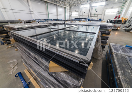 Stacks of pvc windows are waiting for delivery in a distribution warehouse Stacks of pvc windows are waiting for delivery in a distribution warehouse 125700353