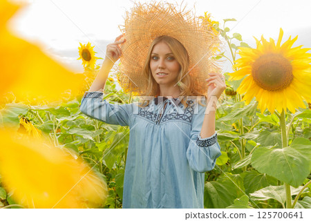 Portrait of a pretty girl in a field of sunflowers. Portrait of a pretty girl in a field of sunflowers. 125700641