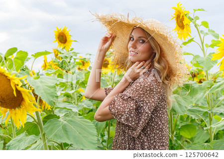 Portrait of a pretty girl in a field of sunflowers. Portrait of a pretty girl in a field of sunflowers. 125700642