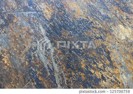 Natural rugged stone texture with earthy tones 125700759