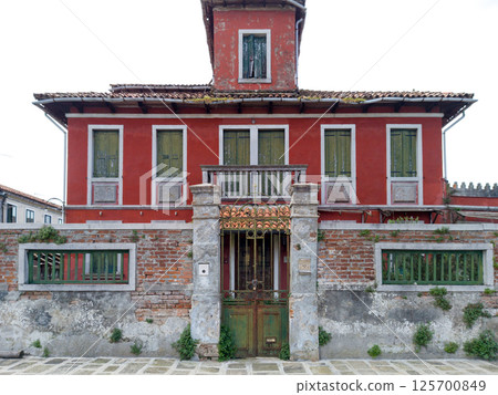 Old Red Villa with Shuttered Windows and Iron Gate 125700849