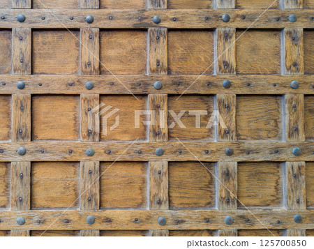 Close Up of Rustic Wooden Door with Metal Studs 125700850