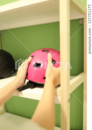 Bicycle Helmet in the Shelf 125701275