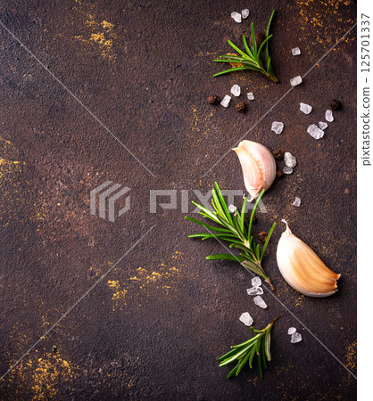 Rosemary, garlic, salt and pepper. 125701337